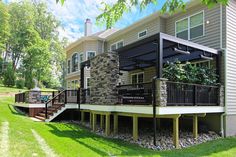 a house with a deck and stone wall