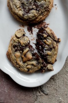 three chocolate chip cookies on a white plate