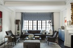 a living room filled with furniture next to a fire place in front of a window