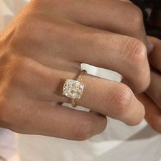 a close up of a person wearing a ring with a diamond on it's finger