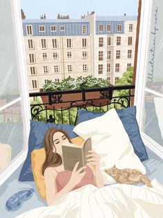 a woman laying in bed reading a book with a cat sitting on the pillow next to her