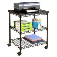 a printer is sitting on top of a metal shelf with books and magazines in front of it