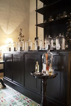 a room filled with lots of clutter and bottles on top of a wooden table