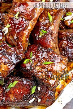 barbecued ribs with sauce and garnishes on a plate