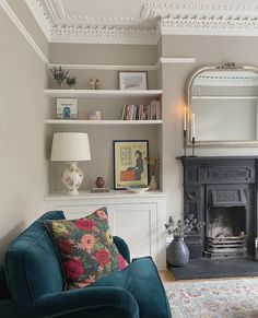 a living room filled with furniture and a fire place next to a mirror on the wall