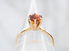 This ring has got it all! An eye-catching solitaire of hessonite garnet, nestled in a gleaming yellow gold setting. The perfect touch of classiness and chic for your ring collection. Who's ready to spin some heads?Metal: 14K Yellow GoldGem: Hessonite Garnet 1.18 CaratsGem Measurements: 5.9 mm, RoundRing Size: 6.50Marks: "14K" Stamped on the inside band Formal Citrine Solitaire Birthstone Ring, Classic Orange Topaz Ring With Prong Setting, Classic Orange Topaz Round Ring, Elegant Orange Solitaire Rings, Opal Solitaire Ring, Sapphire Solitaire Ring, Sapphire Solitaire, Hessonite Garnet, Yellow Gold Setting