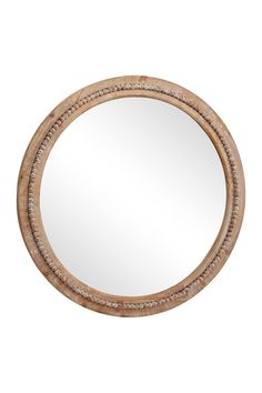 a round wooden mirror with beading around the edges and an oval frame, on a white background