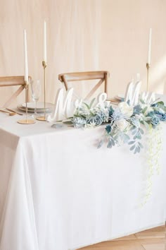 the table is set with candles and flowers