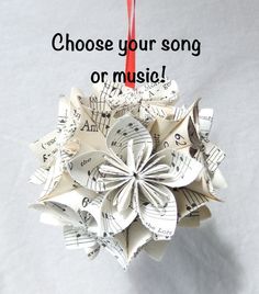 an ornament made out of sheet music paper with the words choose your song on it