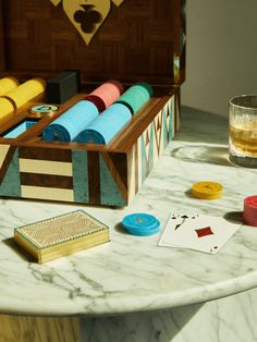 a wooden box filled with different colored threads and cards on top of a table