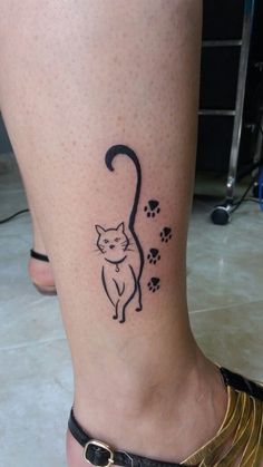 a small cat tattoo on the ankle