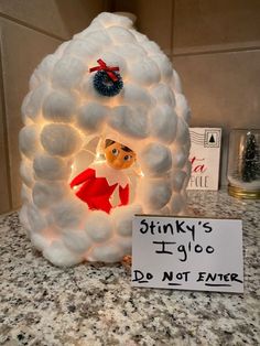 a light up snowman is sitting on the counter next to a sign that says stinky's ugly do not enter