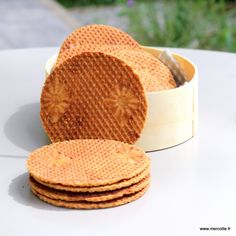 a stack of waffles sitting on top of a table next to a container