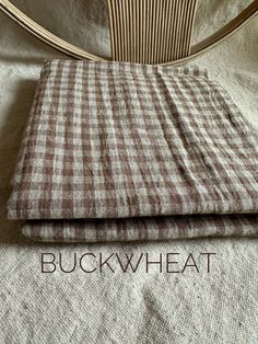 a brown and white checkered blanket sitting on top of a bed