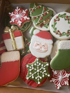 decorated christmas cookies in a box with santa clause