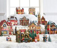 a christmas village is shown in front of a window