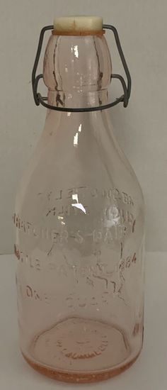 an old glass bottle with a wooden lid