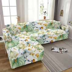 a living room filled with furniture next to a window and rug on top of a hard wood floor