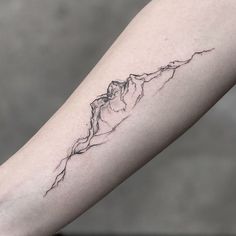 a line work mountain tattoo on the arm