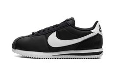 The Women’s Nike Cortez "Black/White" is the women’s sizing of the retro running shoe in a classic colorway.  The Nike Cortez was originally released way back in the 1970s as a performance shoe.  In the years since, the model has been among the most popular lifestyle shoes in the world.  Here, the colorway features a black leather construction with an oversized white leather Swoosh on the sides.  A black suede overlay appears on the toe and more black suede is seen on the eyelets and heel.  “Nik Nike Cortez Black, Black White Shoes, Retro Running Shoes, Lifestyle Shoes, Black And White Shoes, Stadium Goods, Nike Cortez, White Shoes, Running Shoe