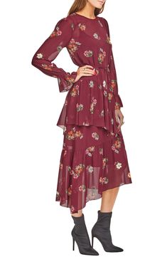 Capitalize on the prairie style trend in this flowy dress featuring abundant ruffles and a sweet floral print. 47 1/2" length Round neck Long sleeves Optional belt Lined 100% polyester Dry clean Imported Savvy Spring Chiffon Midi Dress With Ruffle Hem, Flowy Long Sleeve Tiered Dress With Ruffles, Modest Fall Midi Dress With Ruffle Hem, Modest Ruffle Hem Midi Dress For Fall, Modest Midi Dress With Ruffle Hem For Fall, Chiffon Tiered Dresses For Fall, Modest Flowy Tiered Dress, Tiered Chiffon Fall Dresses, Tiered Chiffon Dresses For Fall