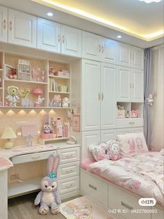 a bedroom with white furniture and pink accessories on the bed, along with a desk