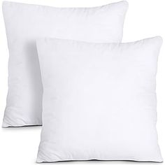 two white pillows sitting next to each other