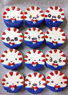 cupcakes decorated with red, white and blue icing are arranged in the shape of cats