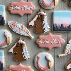 decorated cookies are arranged on a table with pink and blue icing, along with the words annie claire