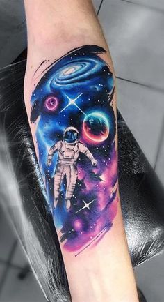 an astronaut tattoo on the arm with stars and planets in the sky behind it,