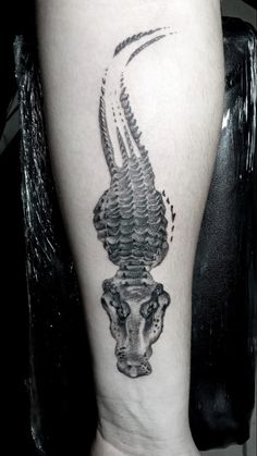 a black and white photo of a tattoo on the leg