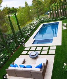 an outdoor living area with a pool and patio furniture