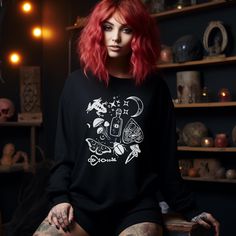 Dark Cottage Core Sweatshirt, Witchy Whimsigoth Clothes, Black with White Print Frog Moth Mushroom Shirts, Forest Core, Plus Size Goth Ideal for any situation, a unisex heavy blend crewneck sweatshirt is pure comfort. These garments are made from polyester and cotton. This combination helps designs come out looking fresh and beautiful. The collar is ribbed knit, so it retains its shape even after washing. There are no itchy side seams on these sweaters.  .: Made with a medium-heavy fabric blend of 50% cotton and 50% polyester (8.0 oz/yd² (271.25 g/m this sweatshirt feels cozy and is the perfect choice for those colder months. .: The classic fit along with the crew neckline deliver a comfy wearing experience with a clean-cut style. Meanwhile, the double-needle stitching at the shoulder, arm Whimsigoth Clothes, Mushroom Shirts, Dark Cottage Core, Plus Size Goth, Forest Core, Clothes Black, Clean Cut, Cottage Core, Heavy Fabric