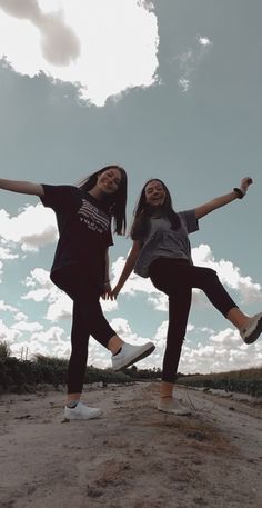 two young women are jumping in the air