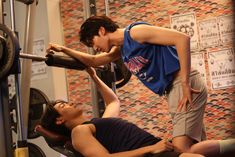 two people doing exercises in a gym