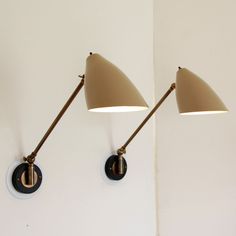 two wall lights on the side of a white wall