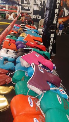 colorful boxing gloves are lined up on the table