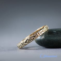 two wedding rings sitting on top of a rock