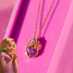 two necklaces with princesses on them and one has a heart shaped pendant in the middle