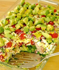 a salad in a glass dish with a fork