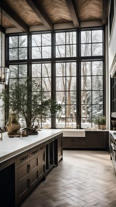 a kitchen with large windows and lots of counter space