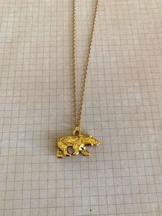 "Nicely detailed double sided gold tone walking bear necklace. Pendant measures 1/2\" L X 1\" W and is on an 18\" chain. ★ Want to see more? Please visit my shop at: https://www.etsy.com/shop/DesignsByPeg" Red Stone Jewelry, Lavender Jewellery, Red Stone Necklace, Emerald Green Necklace, Lavender Necklace, Bear Jewelry, Lavender Stone, Blue Stone Necklace, Bear Necklace