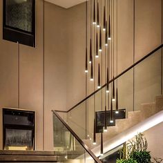 an elegant staircase with glass railings and lights