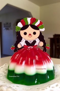 a cake with a doll sitting on top of it