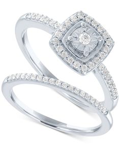 a white gold ring with diamonds on the sides and a diamond set in the middle