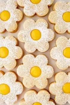 there are many cookies that have been decorated with yellow and white icing on them