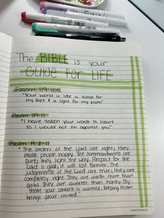 the bible is your guide for life written in green ink on lined paper next to two pens