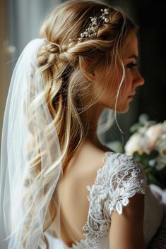 a woman wearing a veil with flowers in her hair