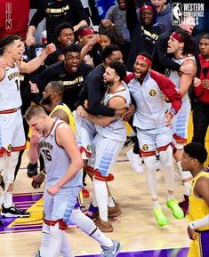 the basketball team is celebrating their win over the lakers in game 4, with fans watching from the sidelines