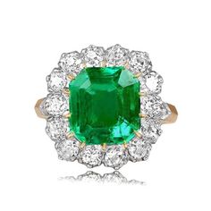 an emerald and diamond cluster ring